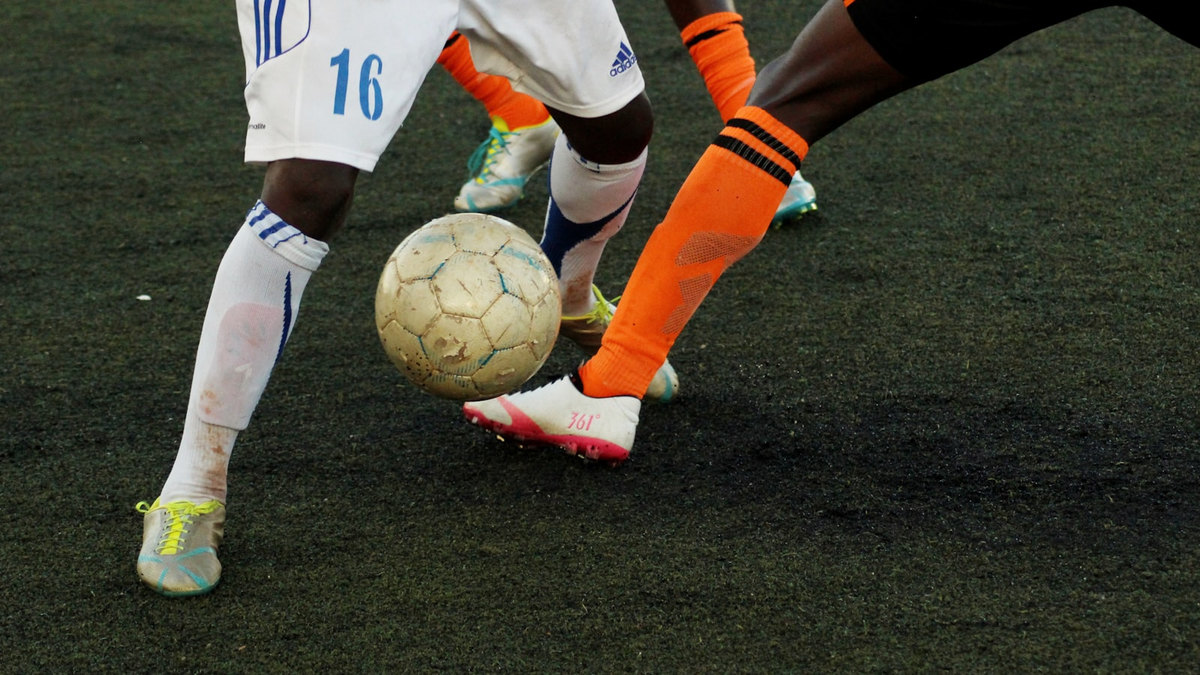 Joueurs de football en action sur un terrain de stade